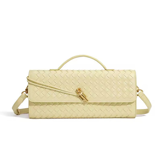 The Andie woven vegan leather shoulder clutch in butter yellow with gold knot toggle and detachable crossbody strap by Karvelle