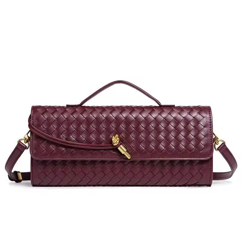 The Andie woven vegan leather shoulder clutch in wine burgundy with gold knot toggle and detachable crossbody strap by Karvelle
