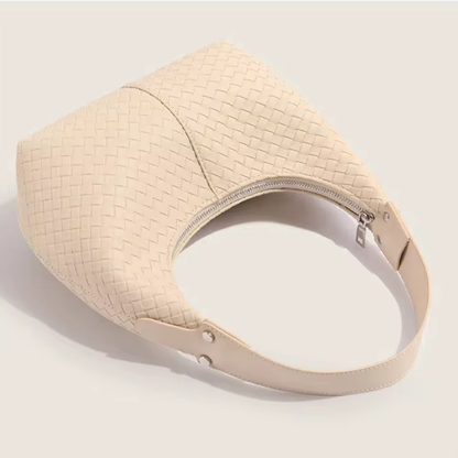 Soft ivory woven mini tote side profile showing depth and strap hardware