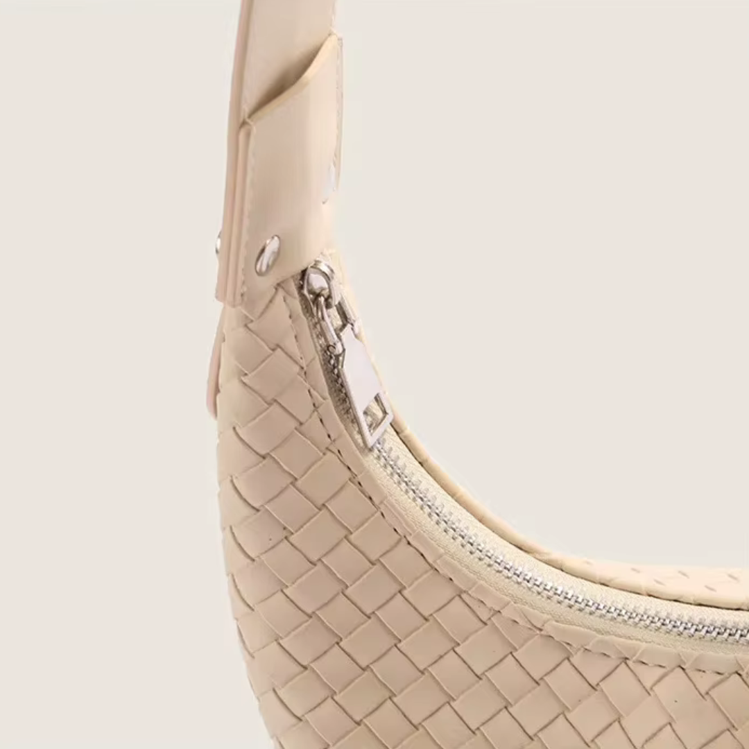 Close-up of premium zipper closure on soft ivory woven mini tote