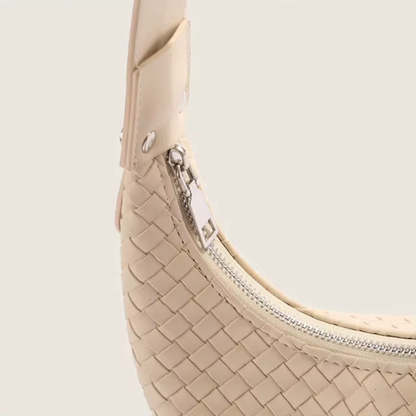Close-up of premium zipper closure on soft ivory woven mini tote