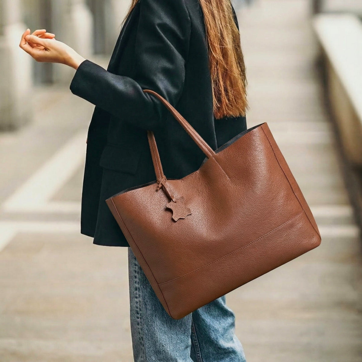 The Isla oversized leather shopper tote in Espresso Brown, worn over the shoulder