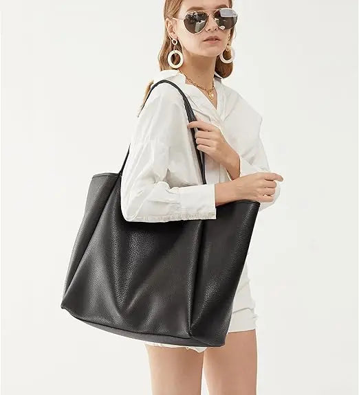 The Juno oversize tote in Black carried on the shoulder