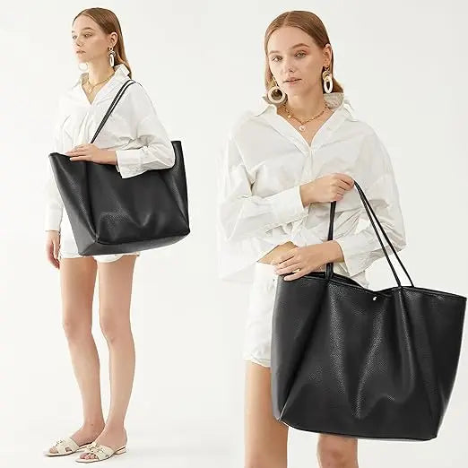The Juno oversize tote in Black worn over the shoulder and carried by hand